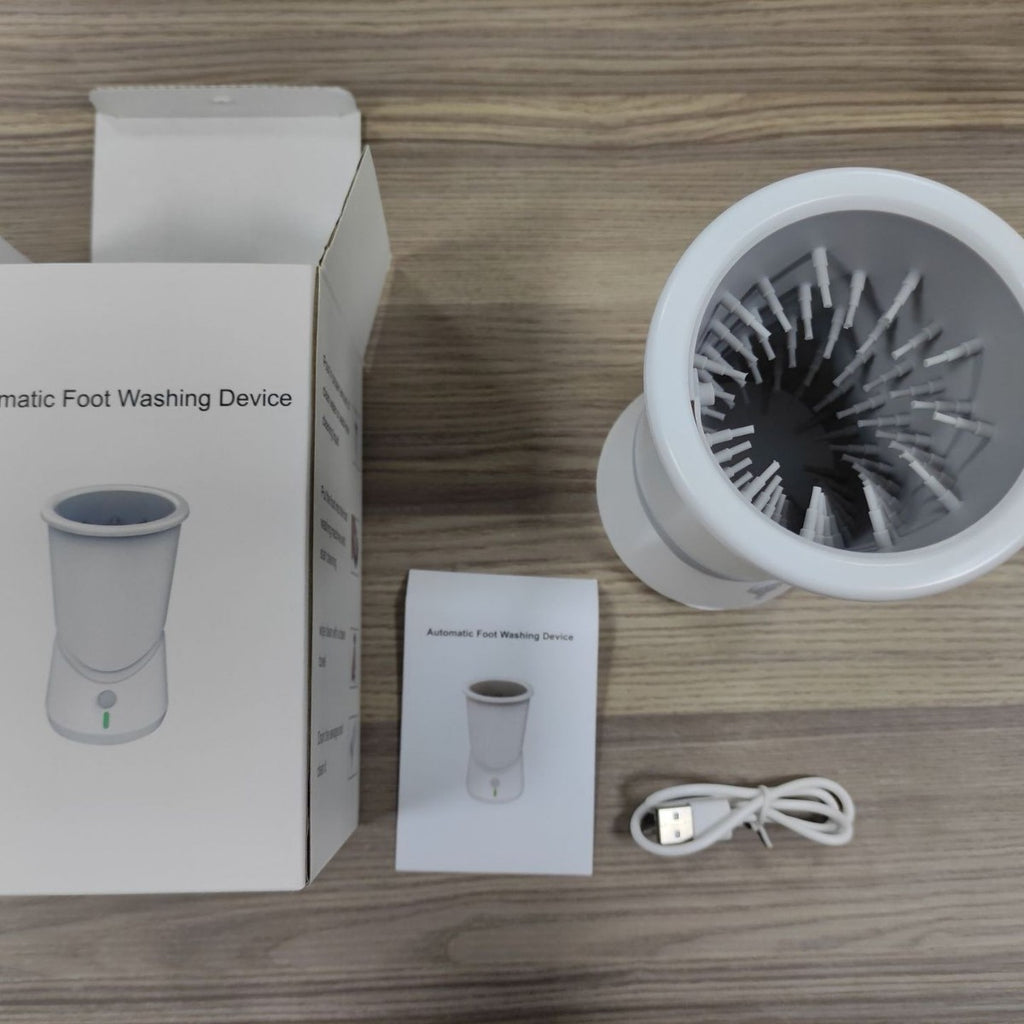 Automatic foot washing device with packaging, user manual, and USB cable on a wooden surface