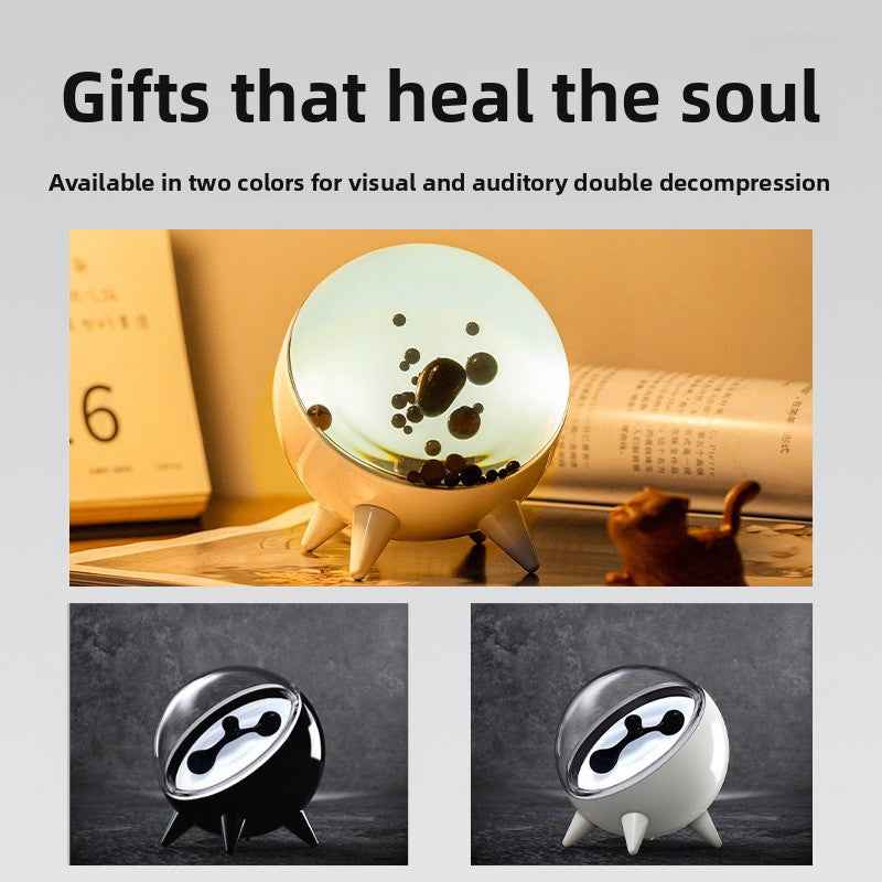 Black ferrofluid audio visualizer with magnetic fluid display for modern workspace