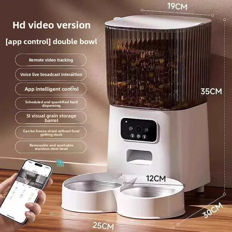 Pet food dispenser with dimensions and app control features on a wooden surface.