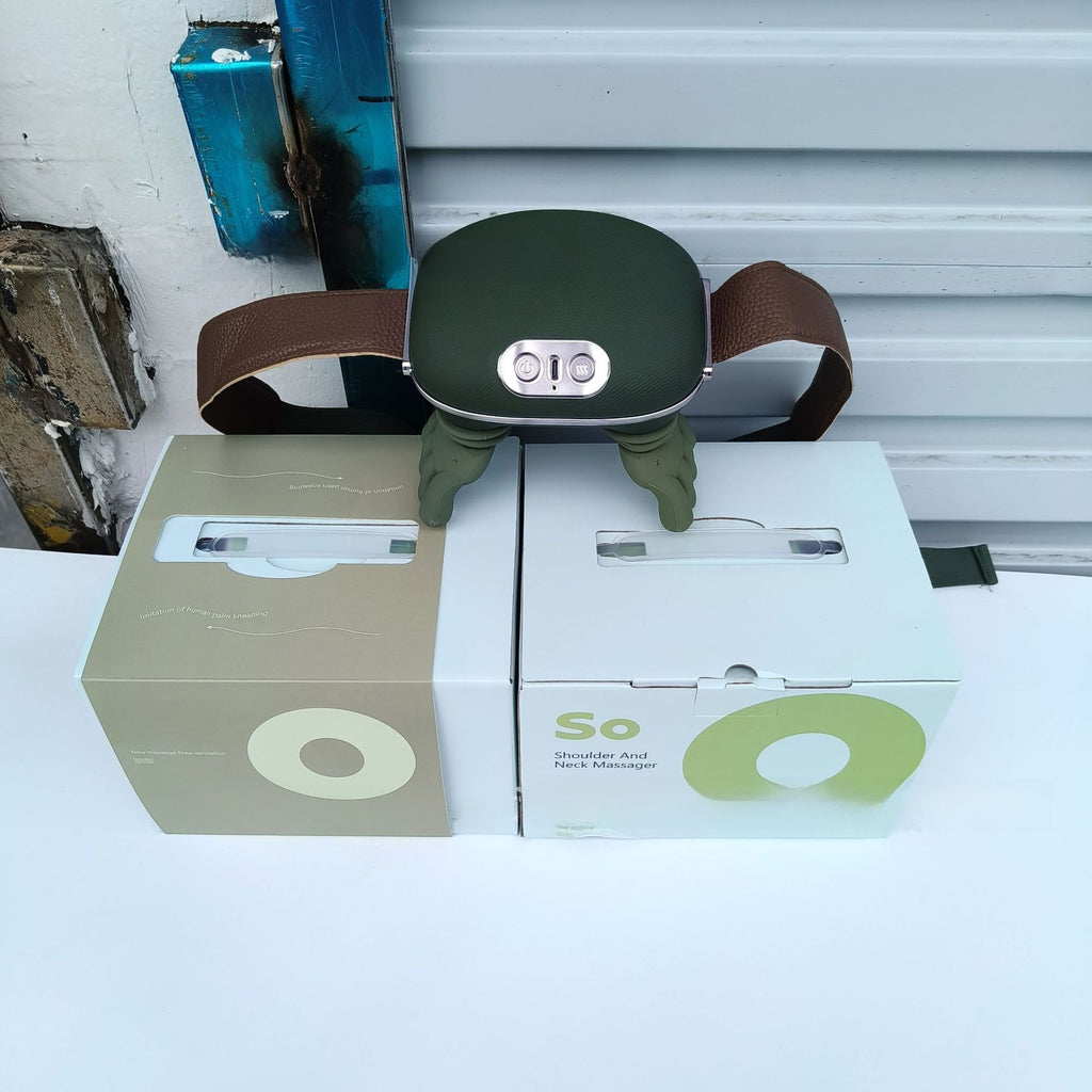 Green neck massager on top of two boxes with visible branding against a white wall.