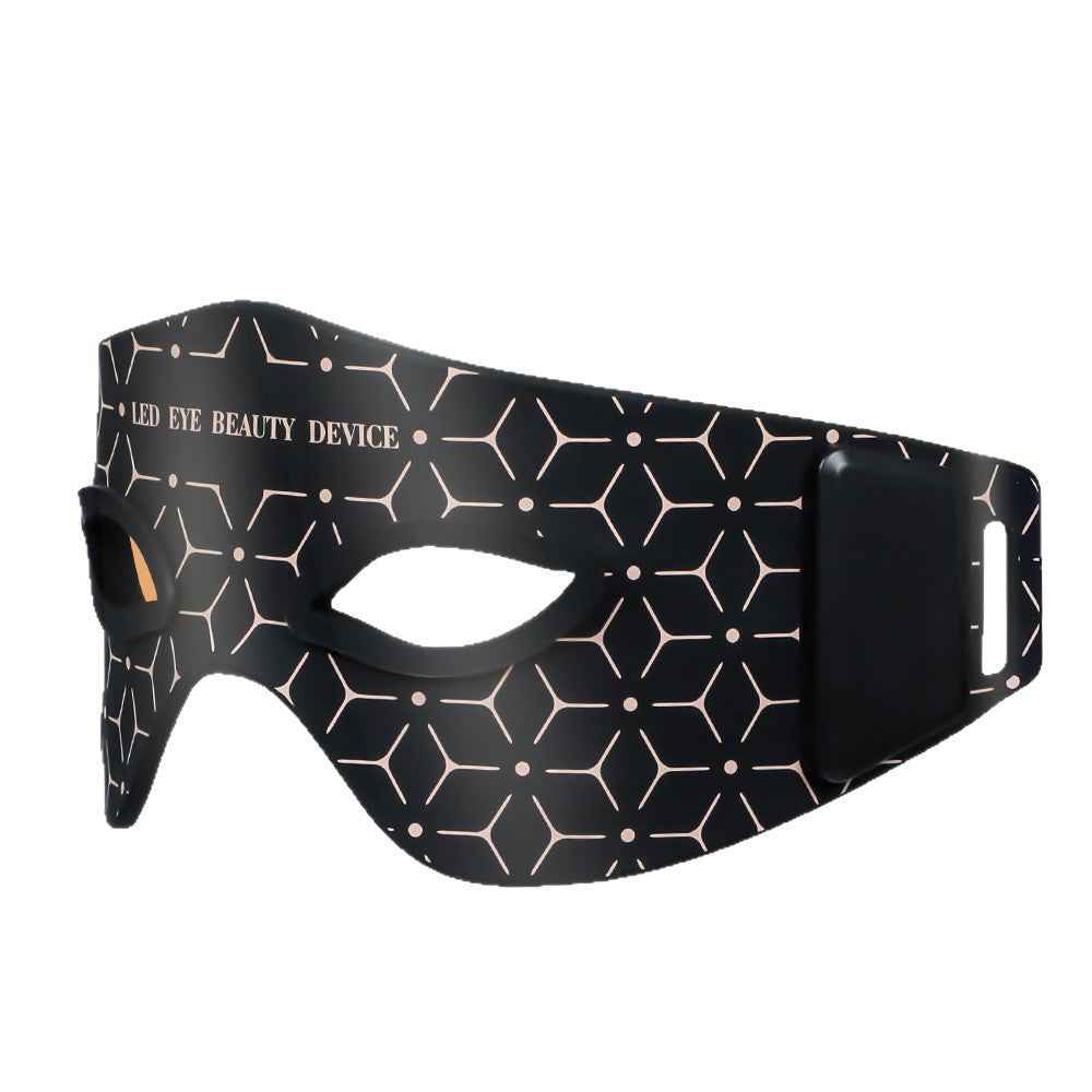 Close-up of eye massager controls showing heat and massage settings